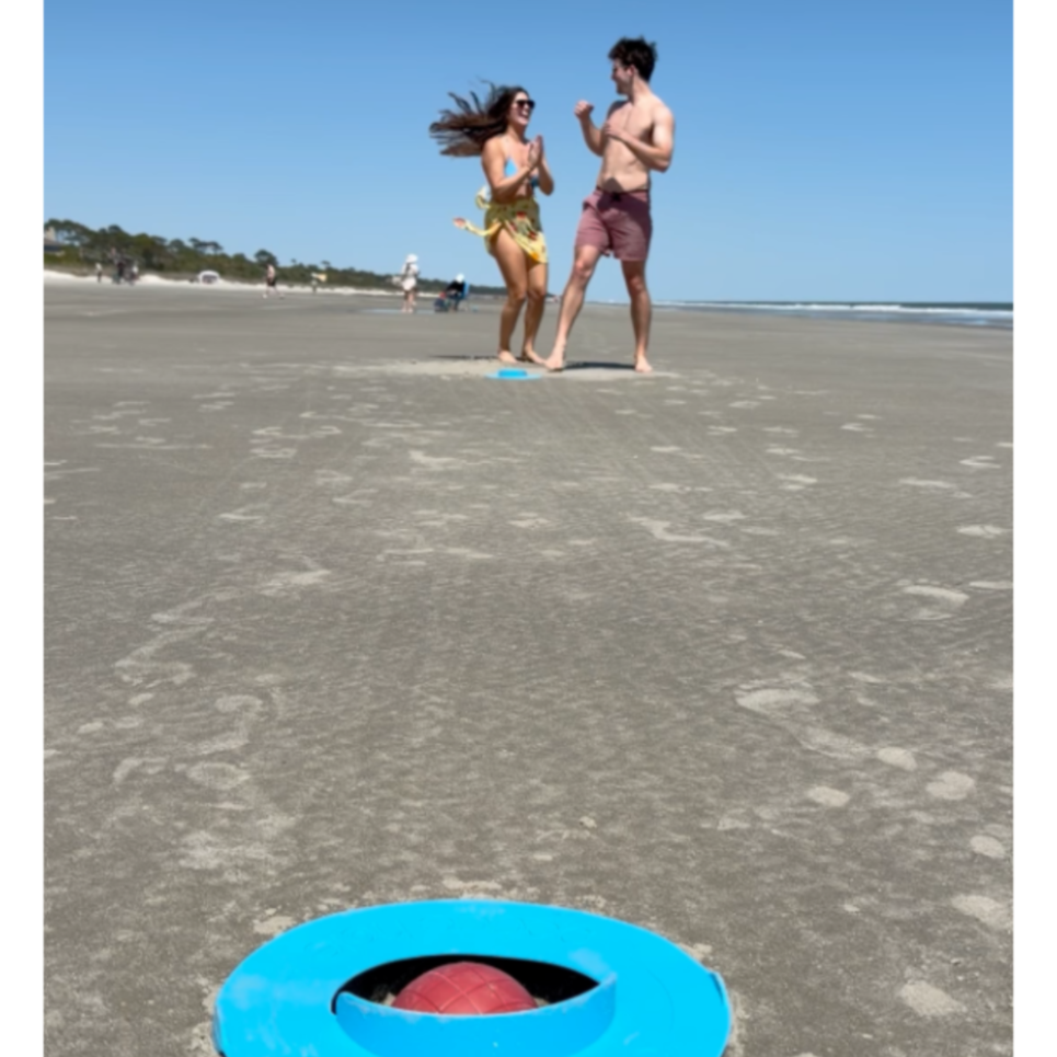 two players celebrate a dramatic score in bocce hole -  the best beach game and even best new beach game of 2026.